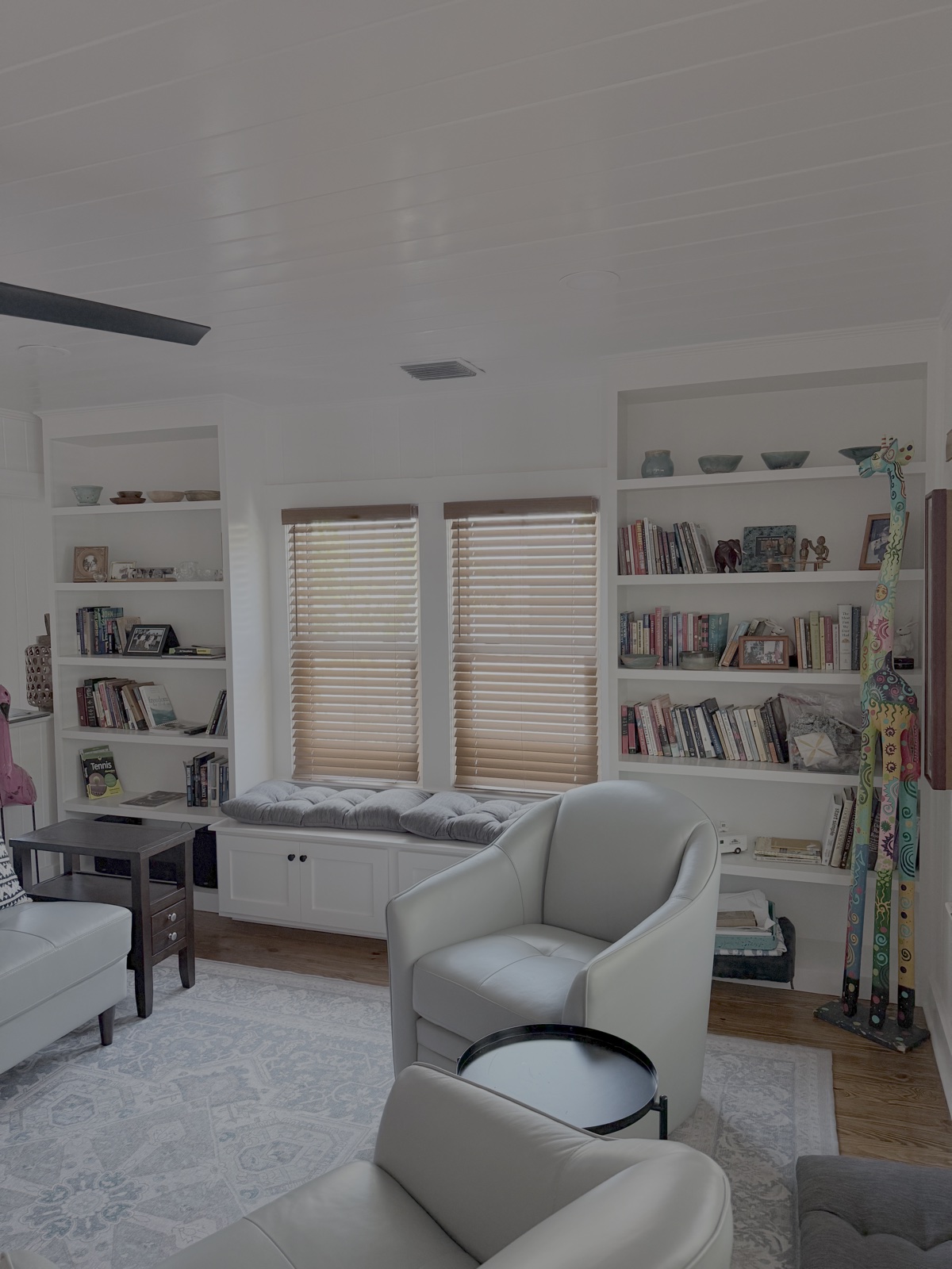Living room built-in bookcase with integrated window bench seat reading nook in Lakewood Ranch FL